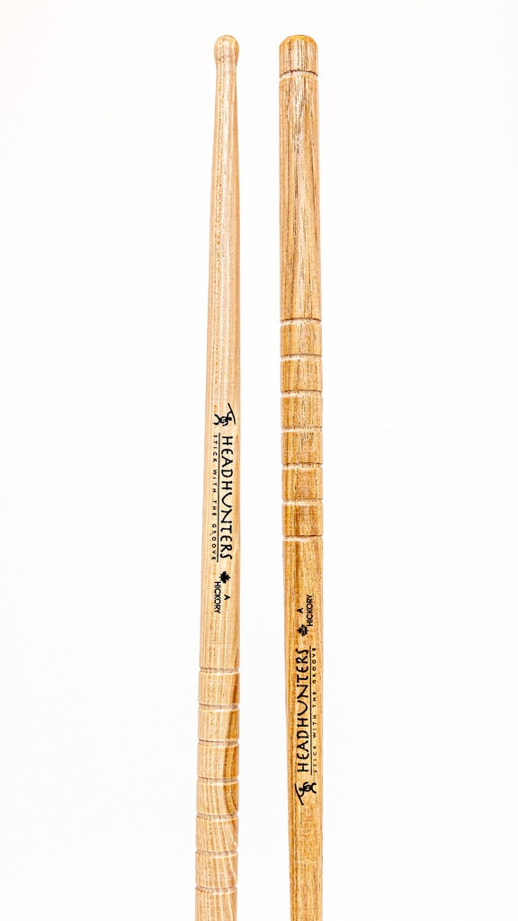 HeadHunters Hickory Grooves A — 416mm, 15.15mm US hickory drumsticks with precision-cut lathed grooves and rounded tip for versatile playing.  Made in Canada