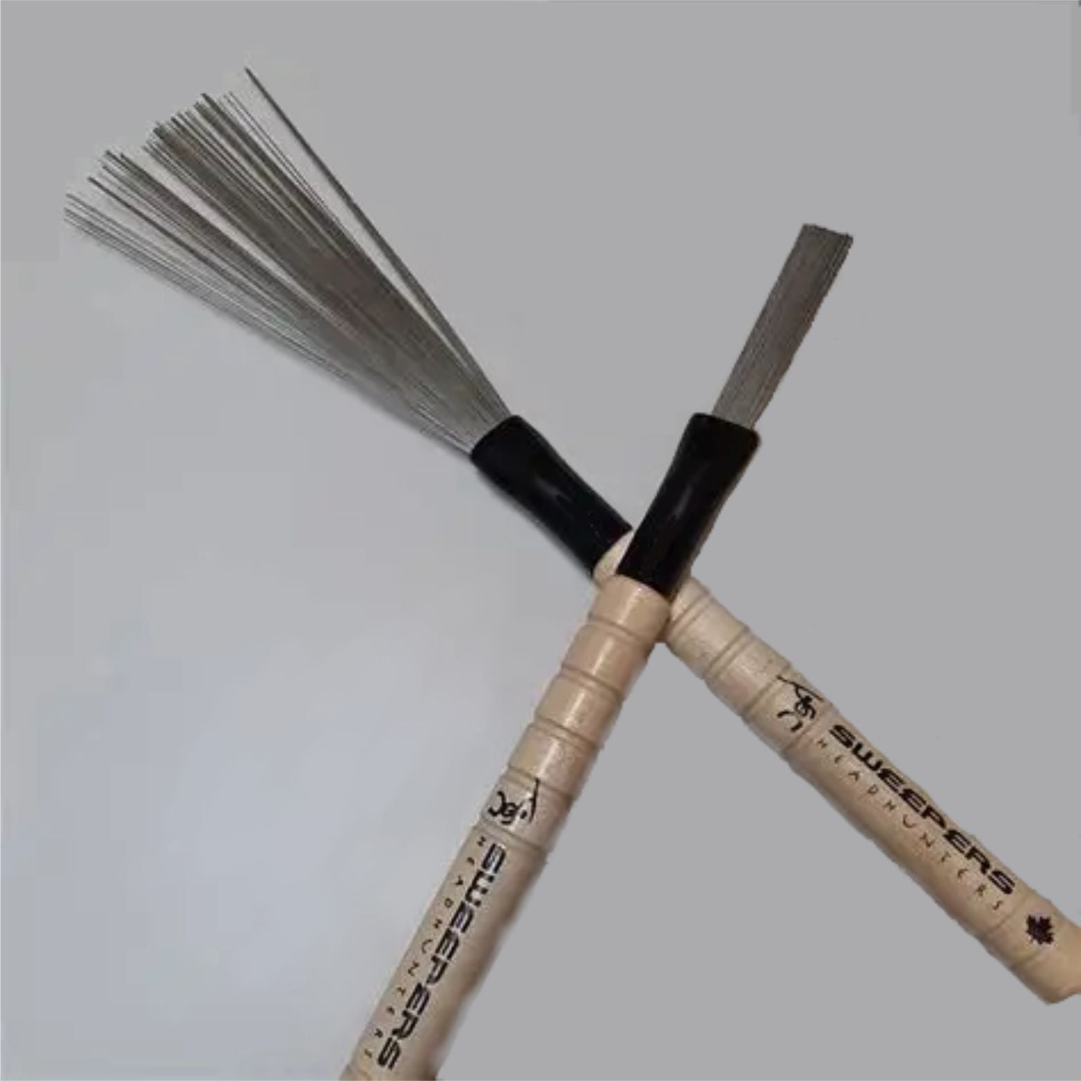 HeadHunters Sweepers — longer semi-retractable wire brushes with wood handle matching Grooves drumsticks. Stick feel, brush performance, Made in Canada.